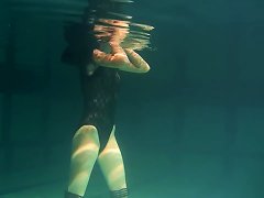 Slim Raven-haired Cutie Undresses While Diving Inside Of A Pool